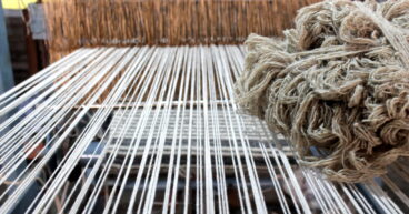 a carpet getting manufactured at a Rug Weavers hand loom in India